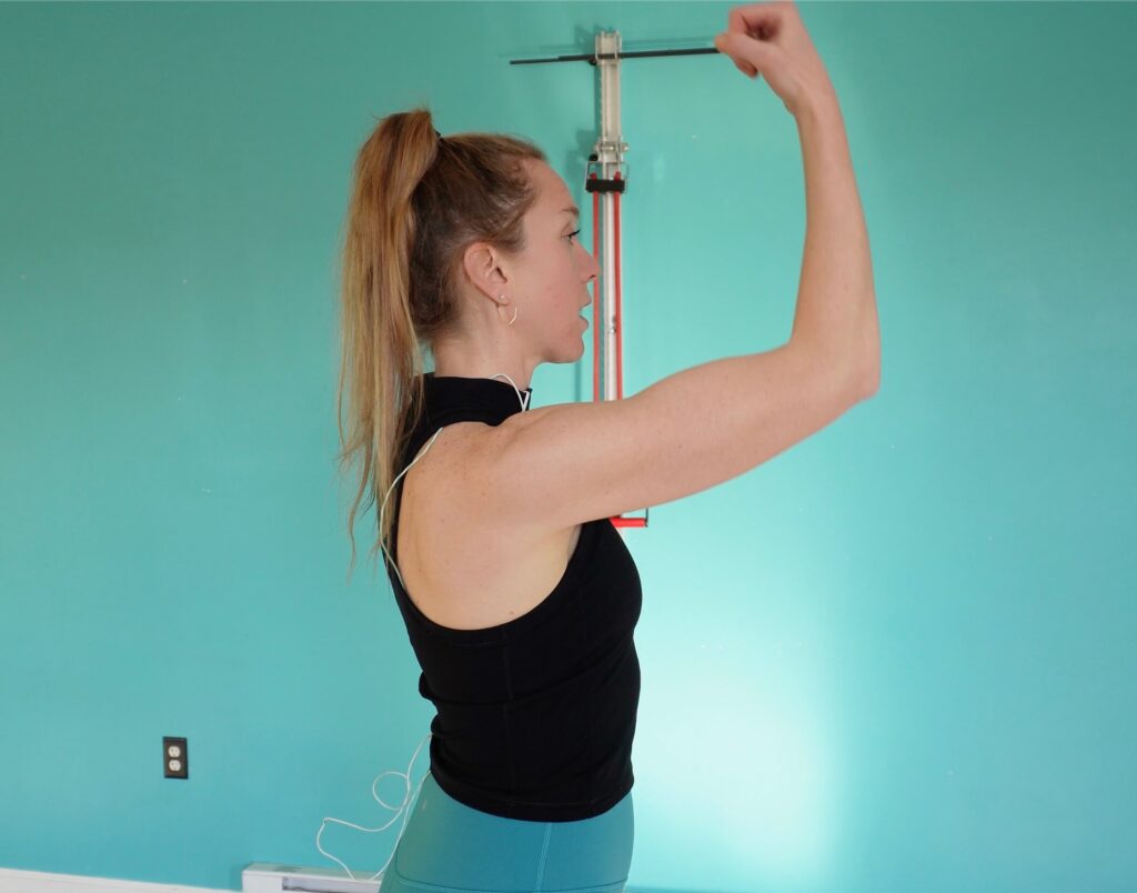 Dr. Chloe lifting her arm to 90 degrees with her arm still bent at 90 for a flexion exercise for a rotator cuff injury